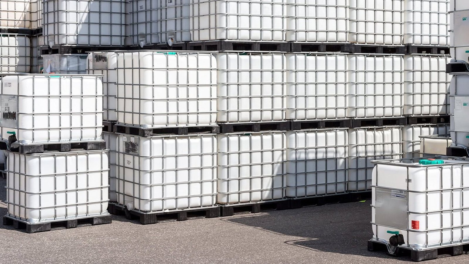 IBC totes stacked two high in a storage yard