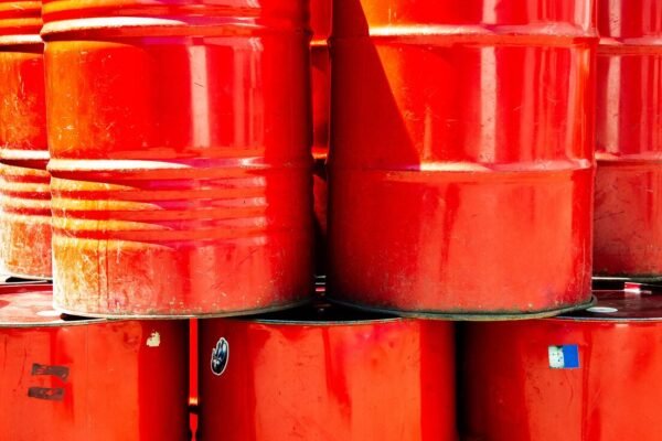 Stacked red steel oil drums