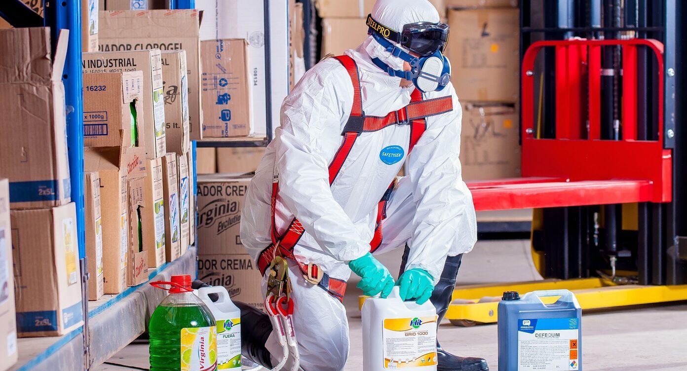 Worker handling chemical containers